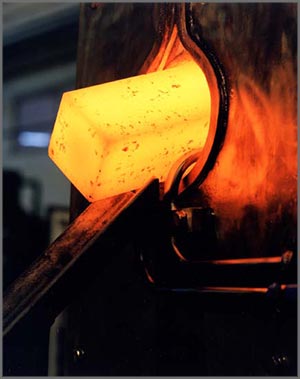 glowing metal being forged